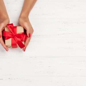 Woman hands holding gift box